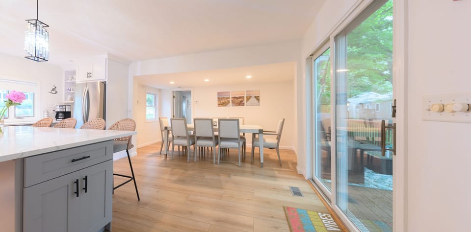 Bright open kitchen & dining space with deck access and plenty of seating