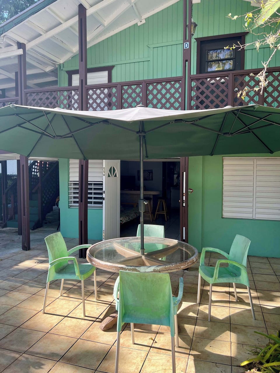 Outdoor patio dining set under a large umbrella, perfect for al fresco meals.
