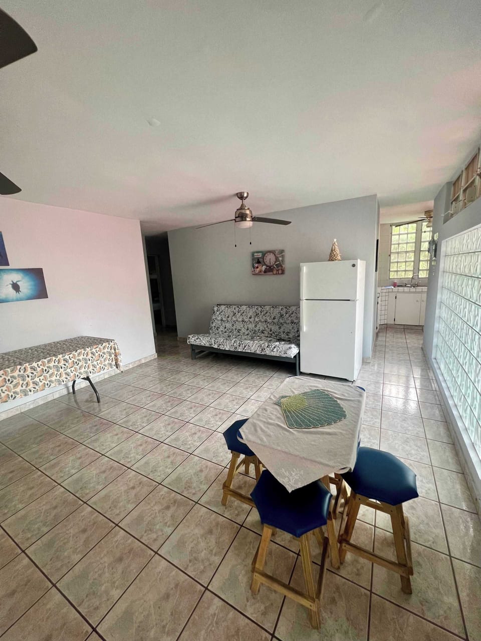 Bright dining area with ceiling fan and seating for the whole group