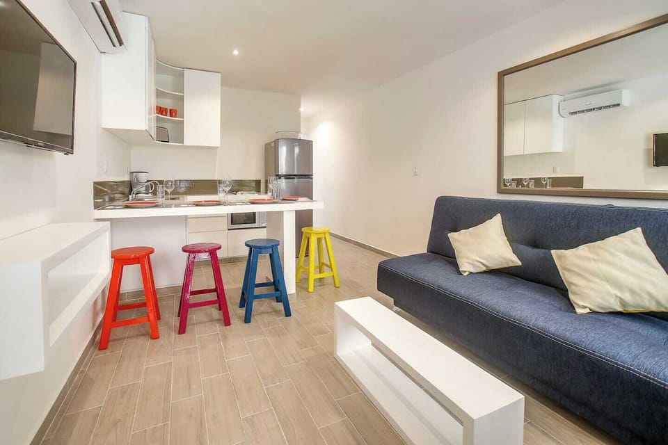 Living room, kitchen and dining. Sofa folds flat for an extra sleeping space 
