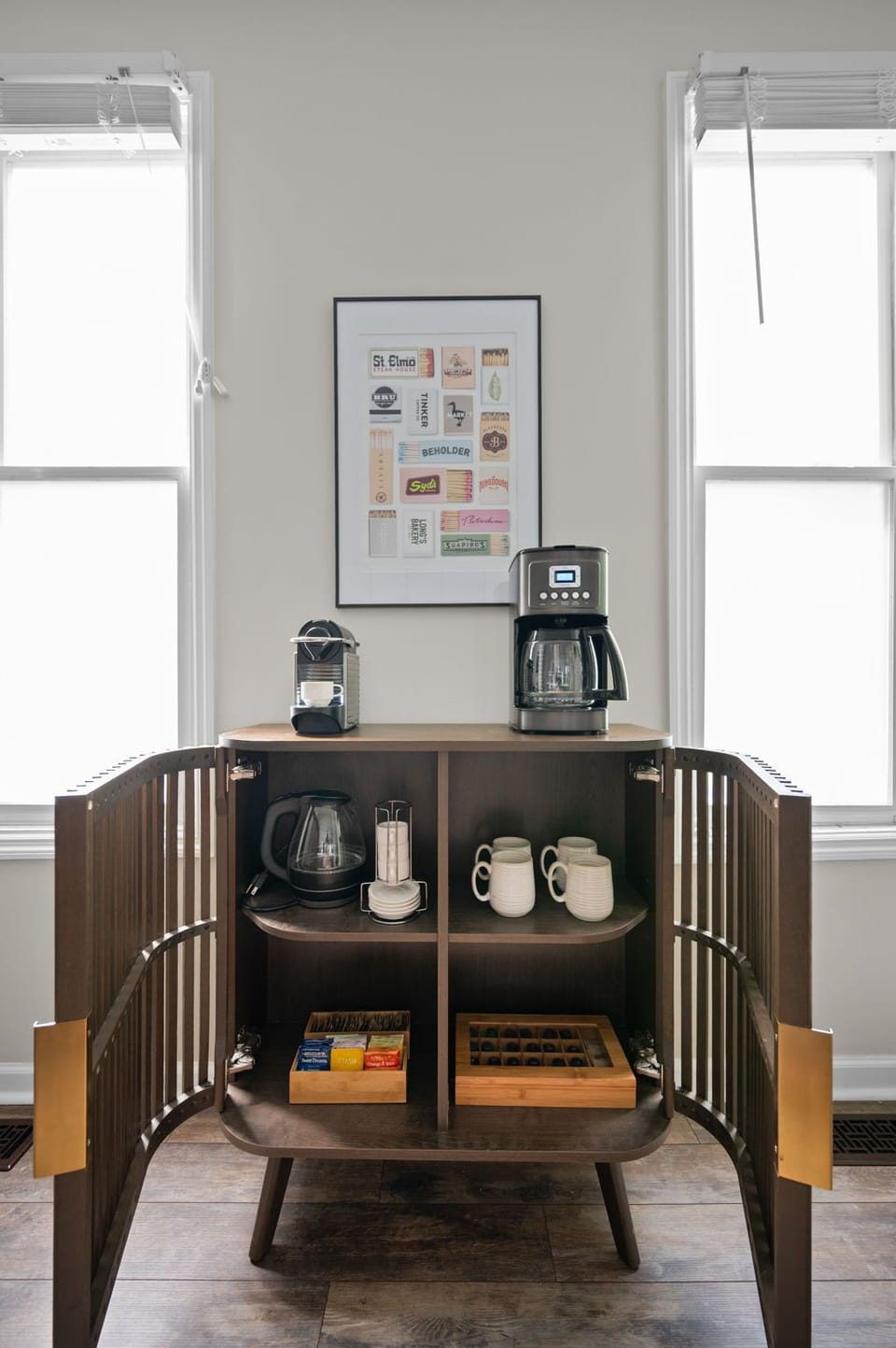 Bright coffee bar with drip coffee, espresso maker, mugs, and tea selection