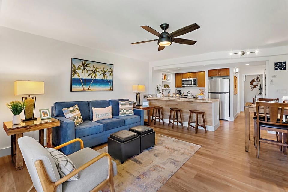 Gather in your open concept living area with plush seating, ceiling fan, and direct access to your private ground floor lanai. PKD-104