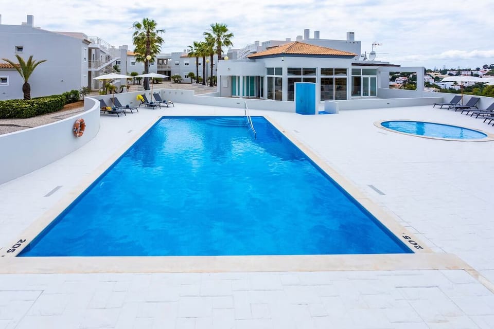Dive into sunlit waters with loungers and wide deck space.
