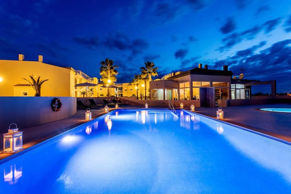 Sip and soak in a serene, blue-lit pool escape.