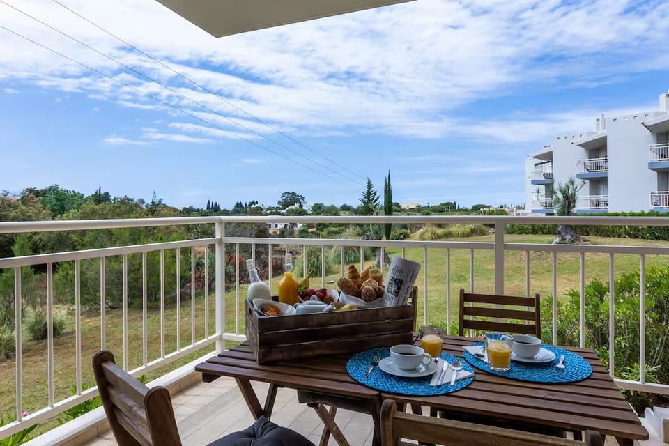 Sip morning coffee outdoors with open skies and green views.