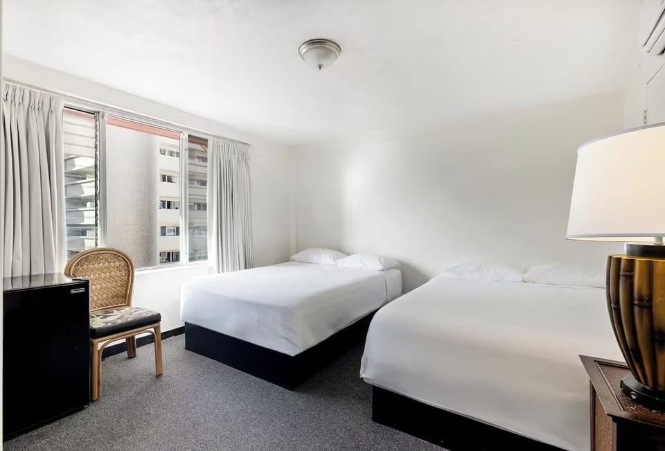 Unwind in bright twin beds with calming city views.