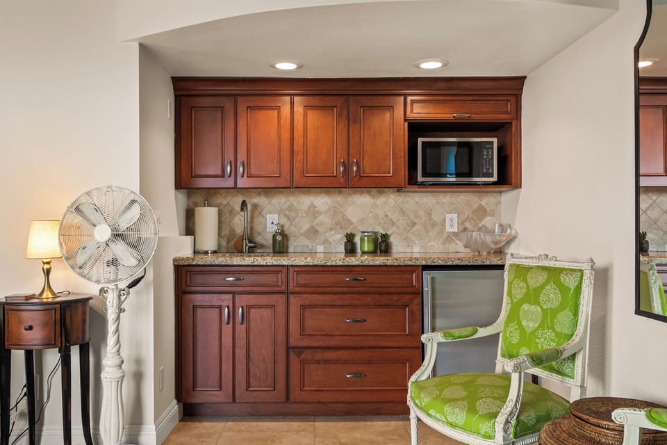 A fully equipped chef's kitchen featuring warm wood cabinetry and modern appliances.