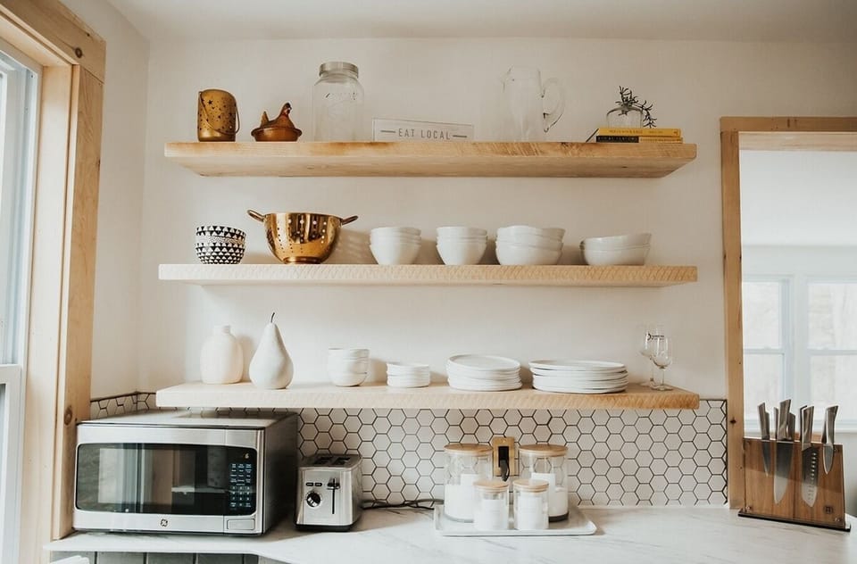 Open concept kitchen = open shelving throughout with custom handmade, rustic barn shelves. Grab some goodies from the local farm markets and make a great meal at home. 