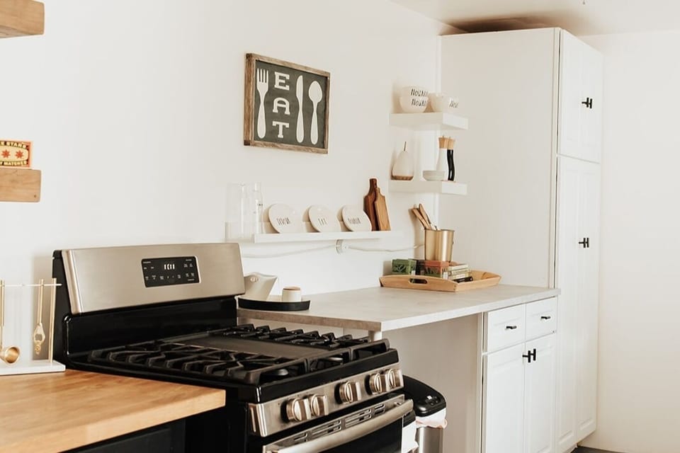 Full galley kitchen with stainless steel GE appliances and everything you need to cook, bake or serve farm market finds. 