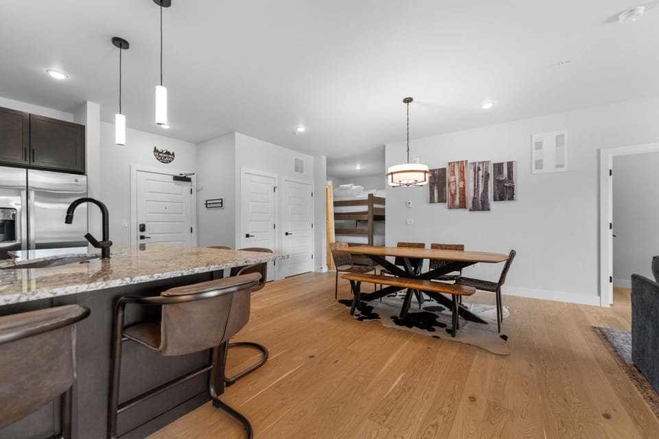 Gather around the rustic dining table or pull up a seat at the granite island—your open, sun-filled space invites easy conversation and memorable meals together.