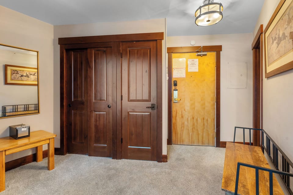 Entryway with a closet and bench.