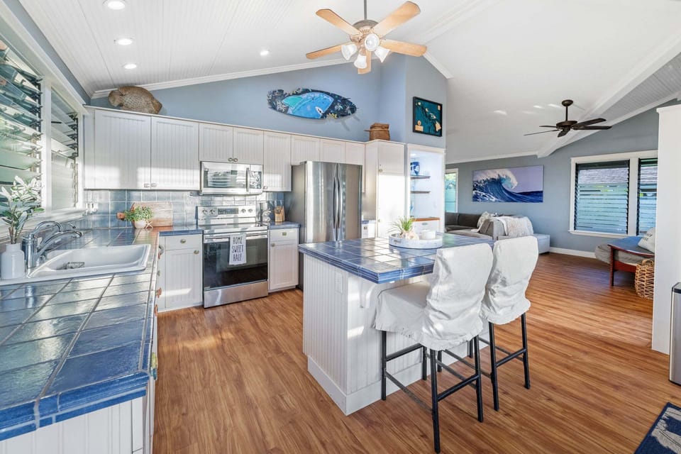 Fully equipped kitchen with breakfast bar seating and open sightlines to living areas.