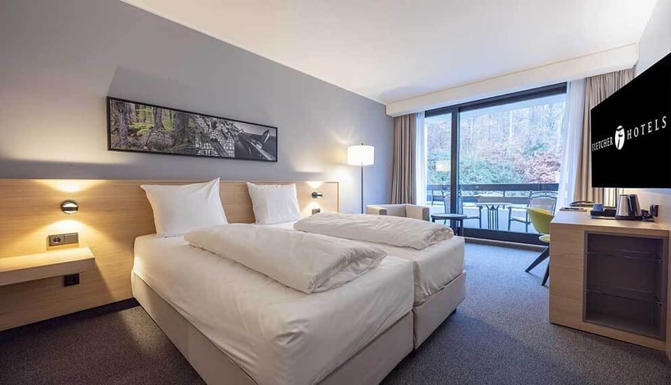 Sink into crisp bedding and savor the peaceful balcony view.