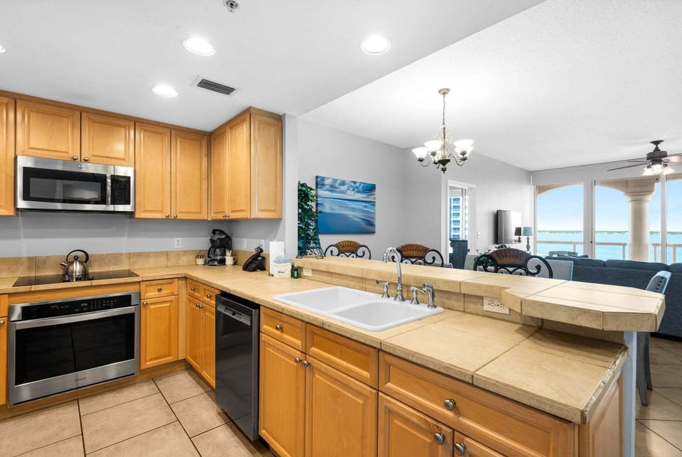Spacious kitchen with bar seating, ample counter space, and an open layout flowing into the dining and living areas.