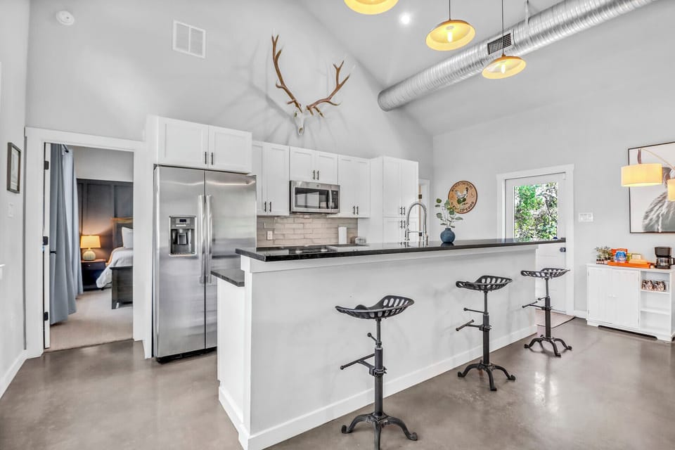 Unwind in your modern open-plan living space where sleek kitchen meets cozy comfort, perfectly designed for memorable evenings together.