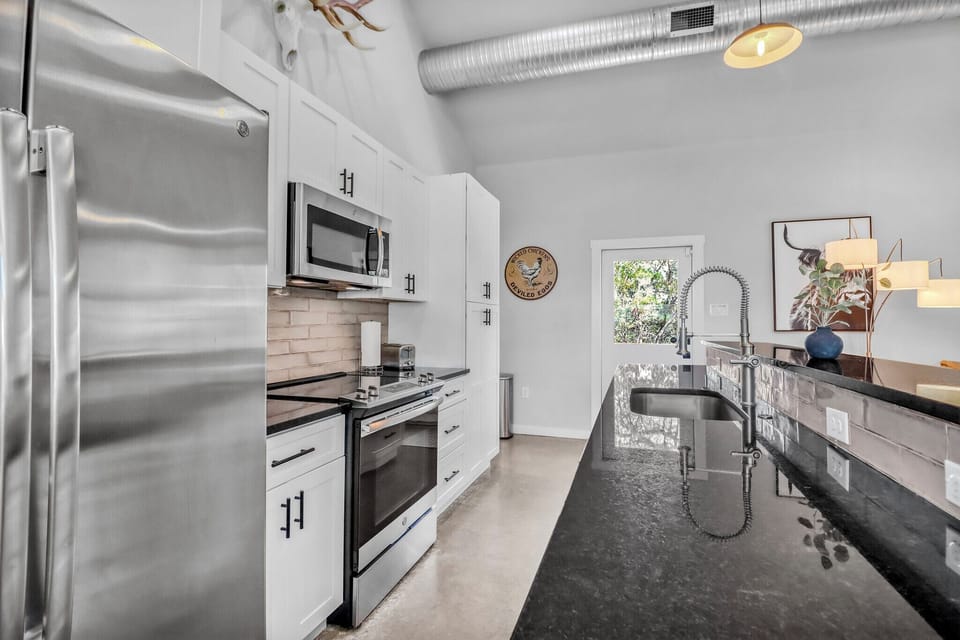 Your modern kitchen features sleek dark countertops, stainless appliances, and everything you need to create memorable meals during your stay.