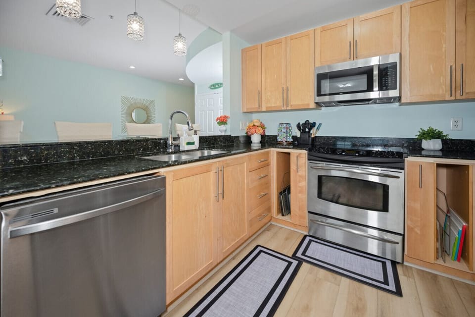 Fully equipped kitchen with stainless appliances—perfect for cooking at home