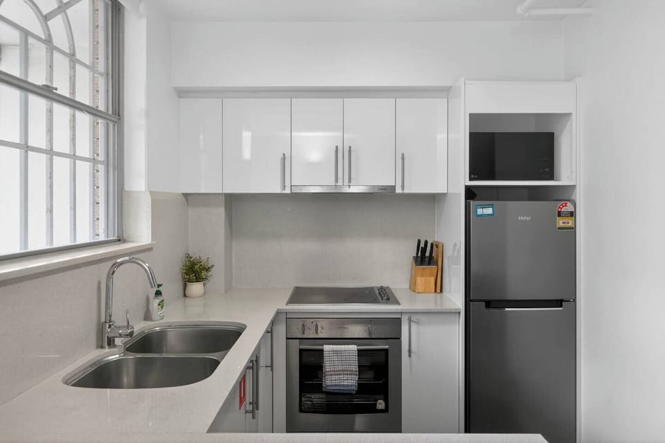 Cook with ease in the streamlined kitchen, where modern appliances and cooking essentials make preparing meals simple and enjoyable.