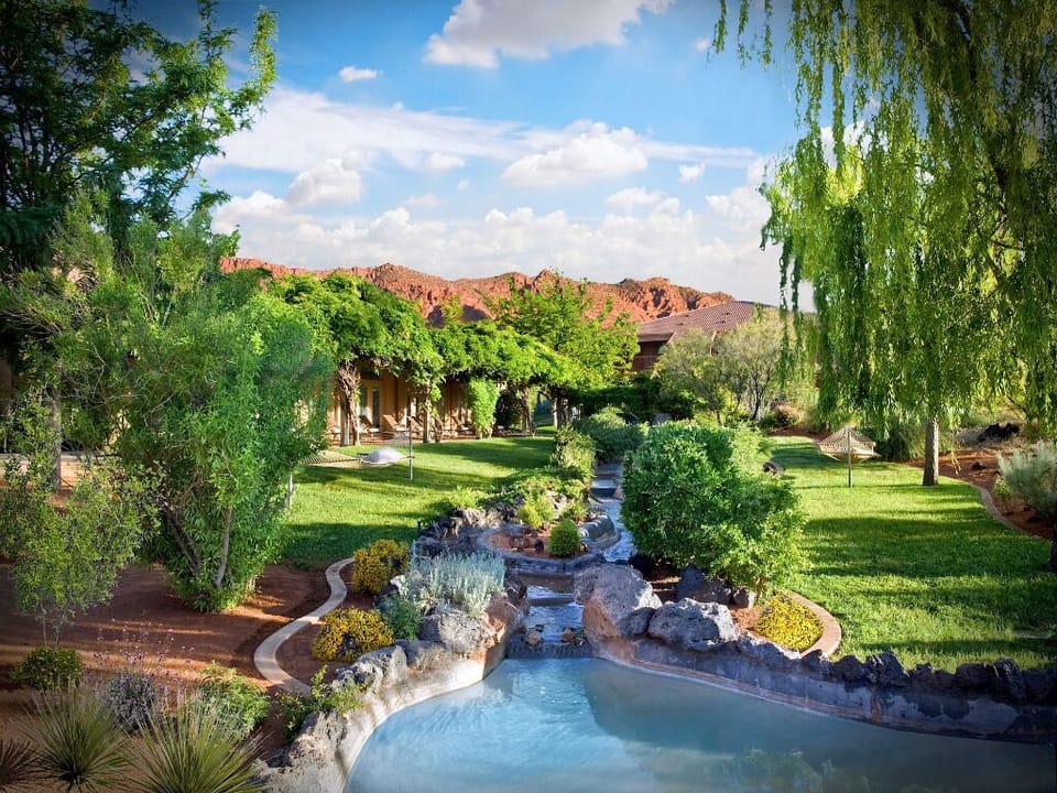 Dive into a serene pool framed by lush gardens