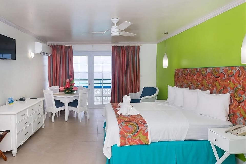 Unwind in a vibrant bedroom with breezy balcony views.