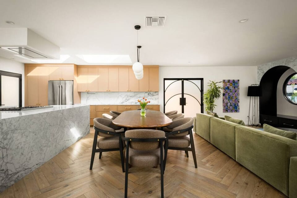 Walnut dining table for eight set beneath skylights and natural light.