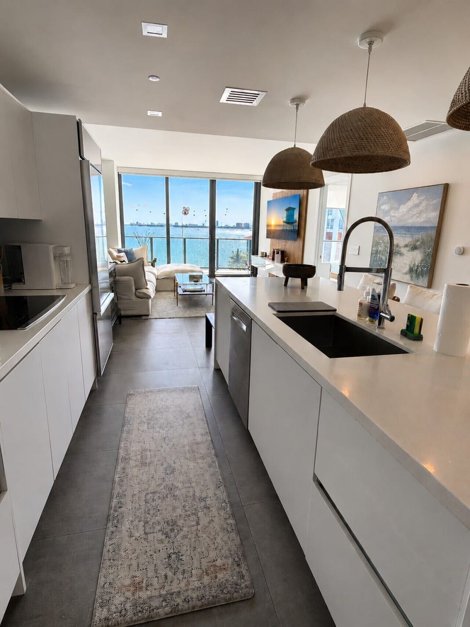 Open-concept kitchen flowing into the living area with unobstructed bay views
