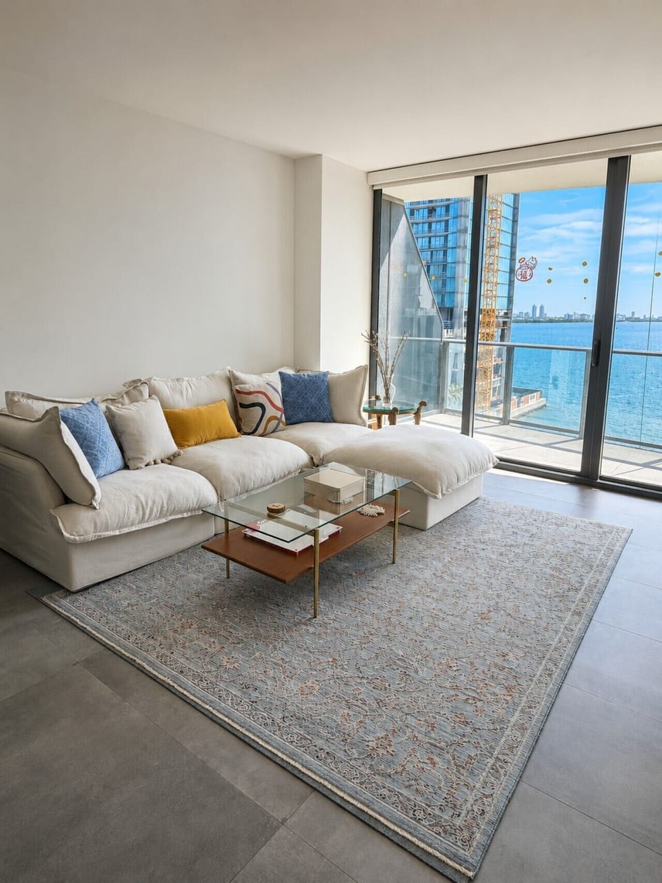 Cozy lounge with natural light and waterfront scenery