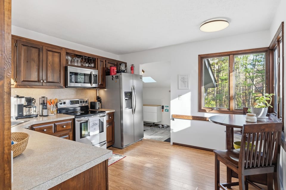 Bright kitchen with stainless steel appliances, ample counter space, and a cozy breakfast nook by the window.