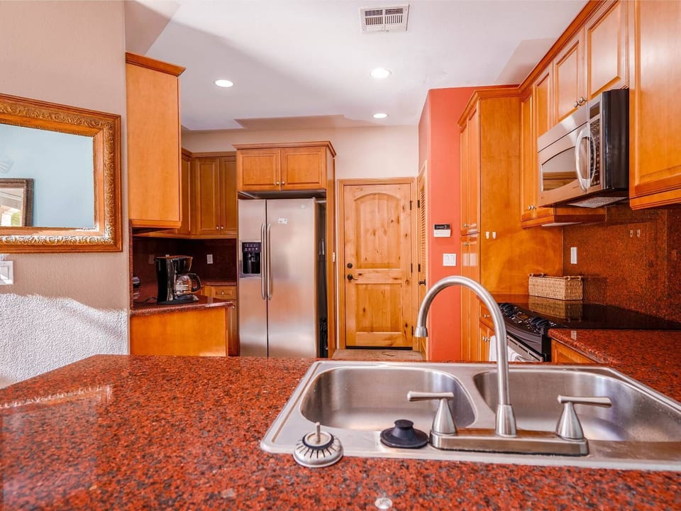 The kitchen opens to a convenient bar area with seating, perfect for casual meals or morning coffee.