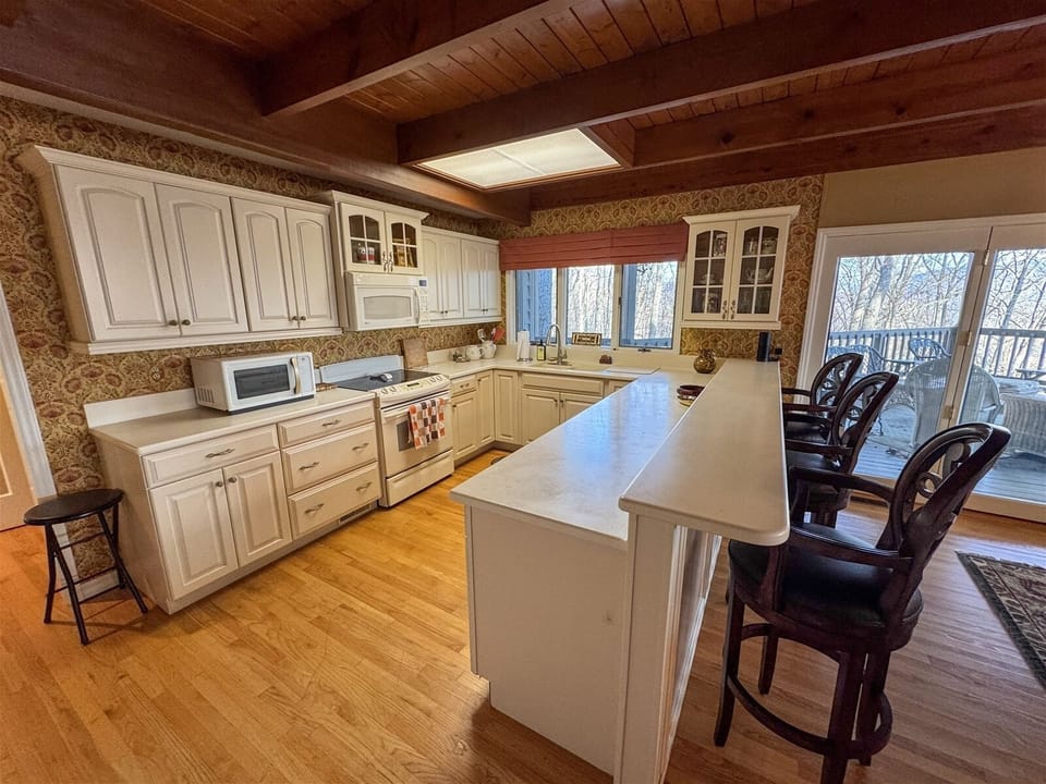 Central Island with bar seating open to Living areas