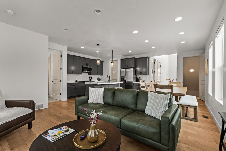 Relax in your stylish open-concept space where the emerald leather sofa invites evening conversations while gourmet meals await in your sleek kitchen.