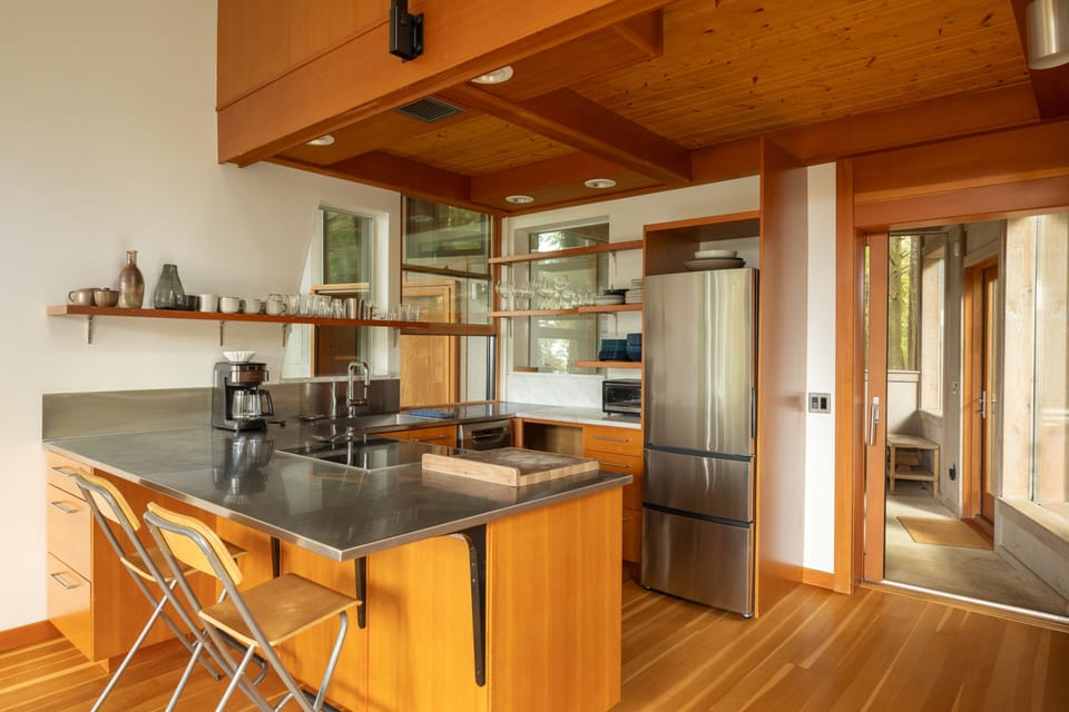 Discover your culinary haven in this modern kitchen featuring sleek countertops, premium appliances, and warm wood accents that invite you to create memorable meals.