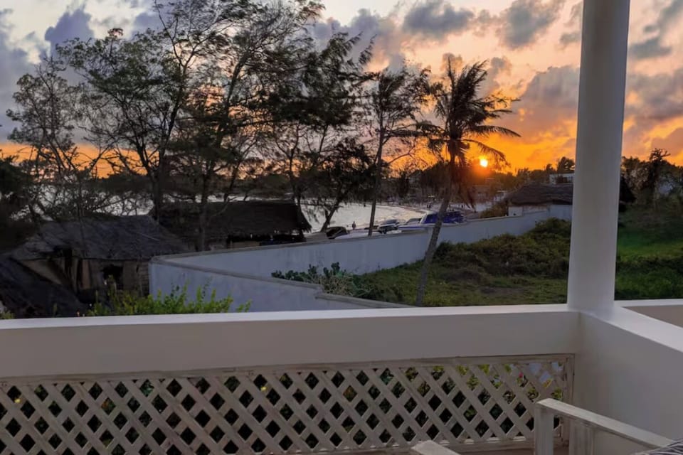 Sip a sunset drink while overlooking palms and ocean air.