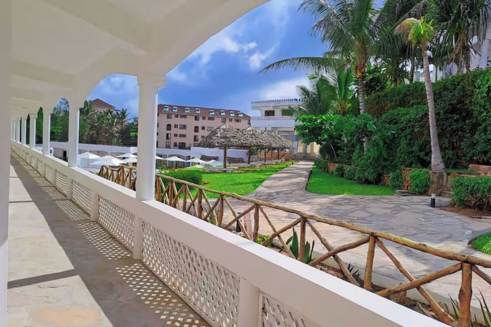 Stroll along shaded walkways framed by palms and gardens.
