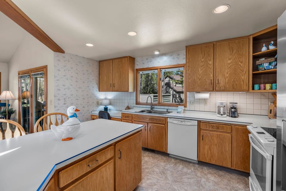 Your spacious kitchen invites culinary adventures with warm wood cabinets, ample counter space, and everything you need for memorable meals.