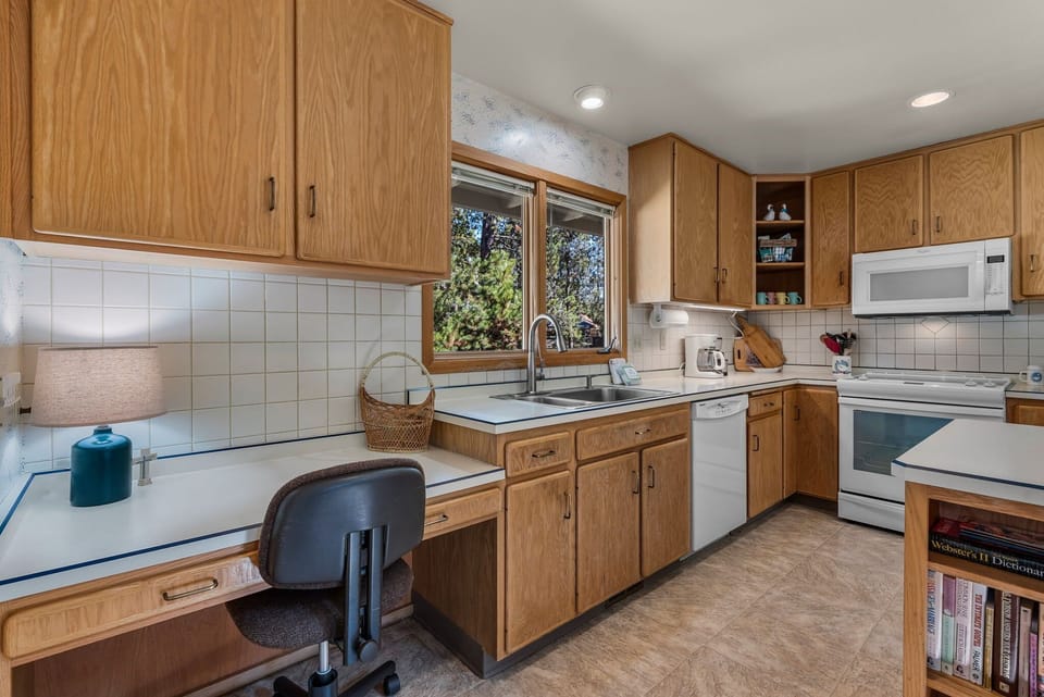 Your fully equipped kitchen offers everything you need to prepare meals while enjoying garden views through the bright windows.