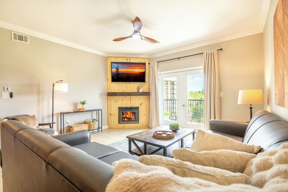Cozy up by your crackling fireplace in this inviting living room, with plush seating and warm lighting creating the perfect retreat.