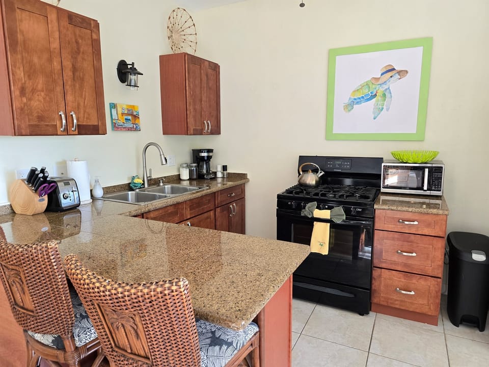 The bright kitchen with bar stools is perfect for mixing up cocktails or preparing a meal with your fellow traveler(s)