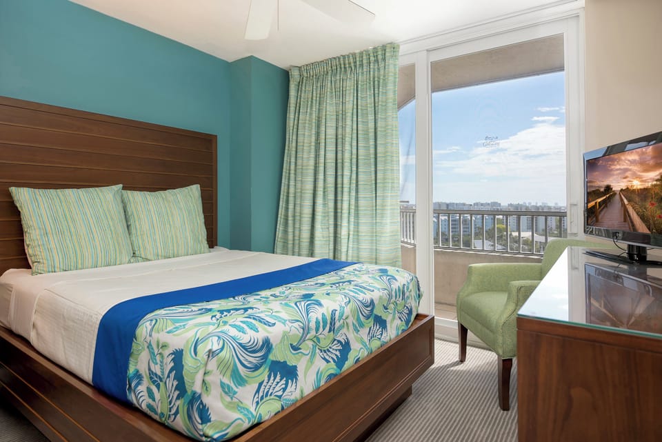 Wake up to bright views in a calm, coastal bedroom.