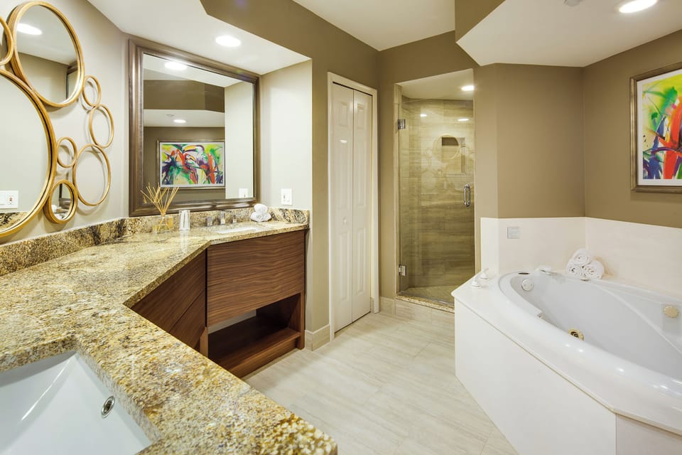 Refresh in a spa-like bath with soaking tub and glass shower.
