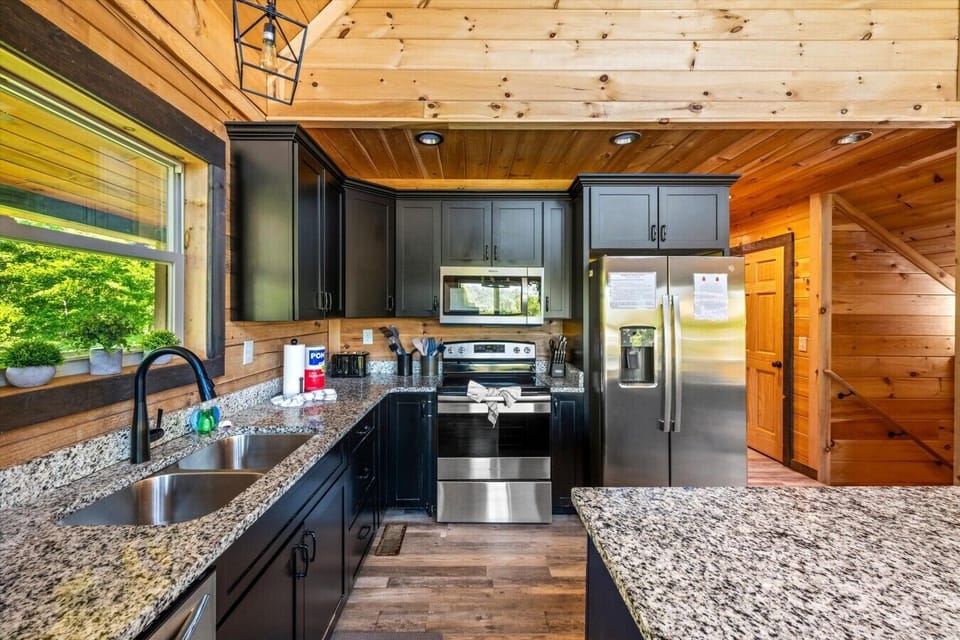 Enjoy the perfect blend of rustic charm and modern convenience with stainless steel appliances, custom cabinetry, and generous workspace.