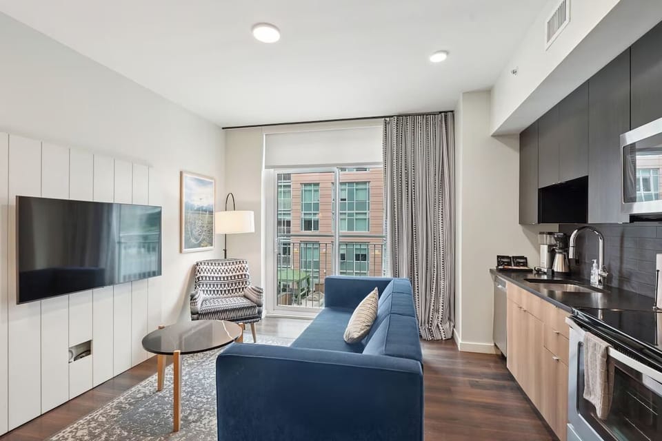 Gather in the sunlit living room with airy seating.