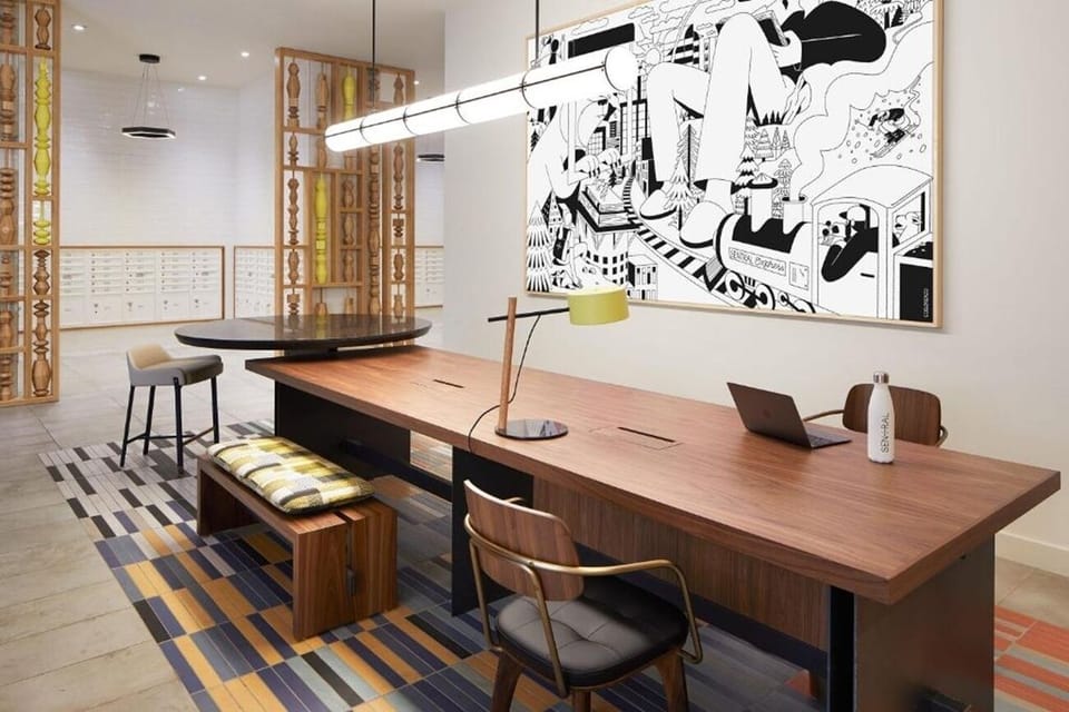 Create and focus at a designer workspace with inspiring mural.