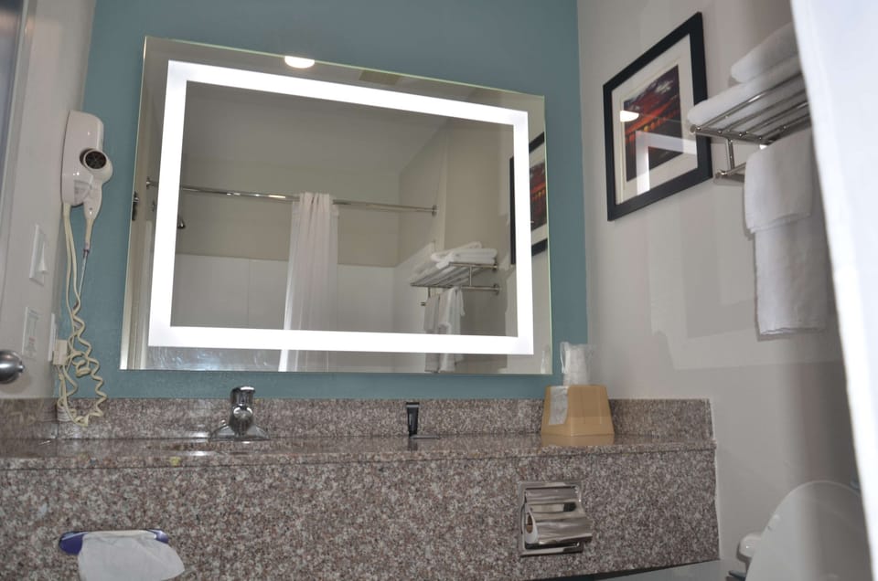 Refresh effortlessly with a well-lit vanity and roomy counter space.