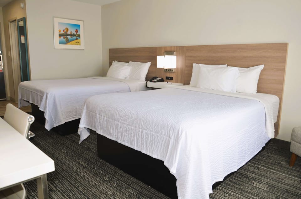 Unwind on crisp white linens in a spacious double-queen room.