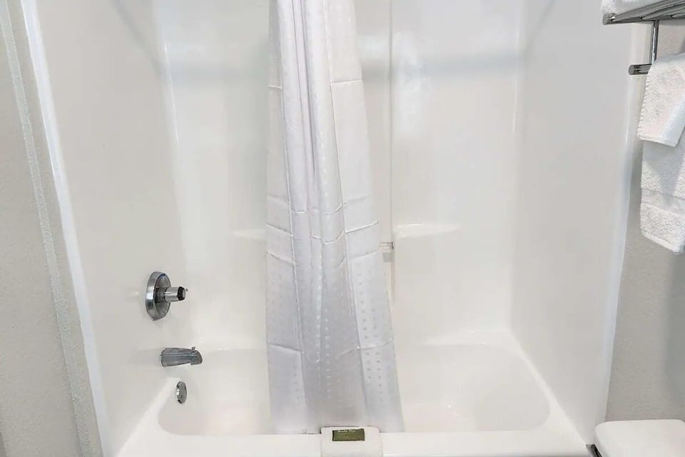 Rinse off in a spotless shower-tub after a long day.