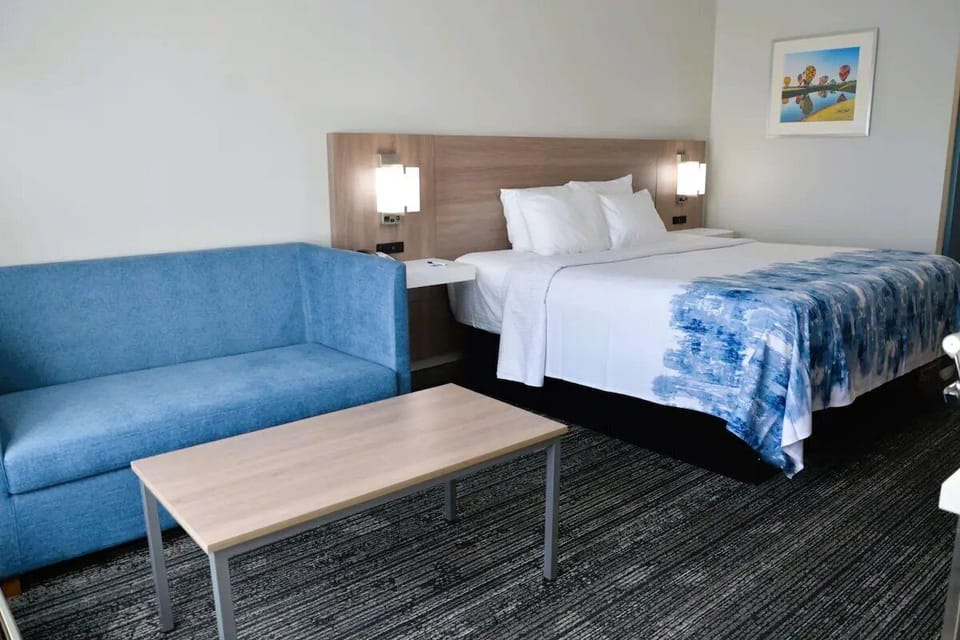 Stretch out with a cozy sofa beside your inviting bed.