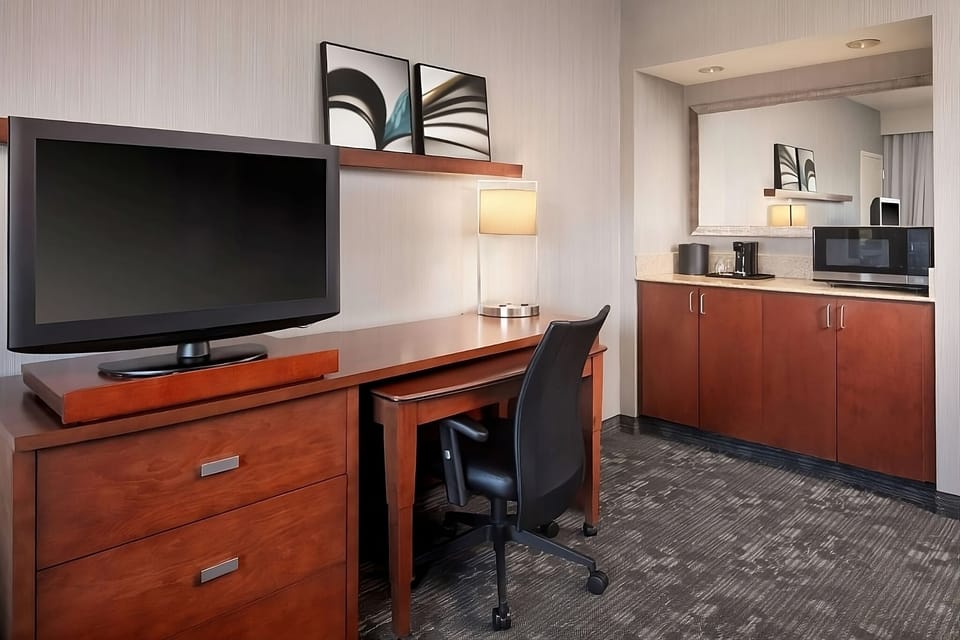 Settle in with a convenient kitchenette, desk, and big TV.