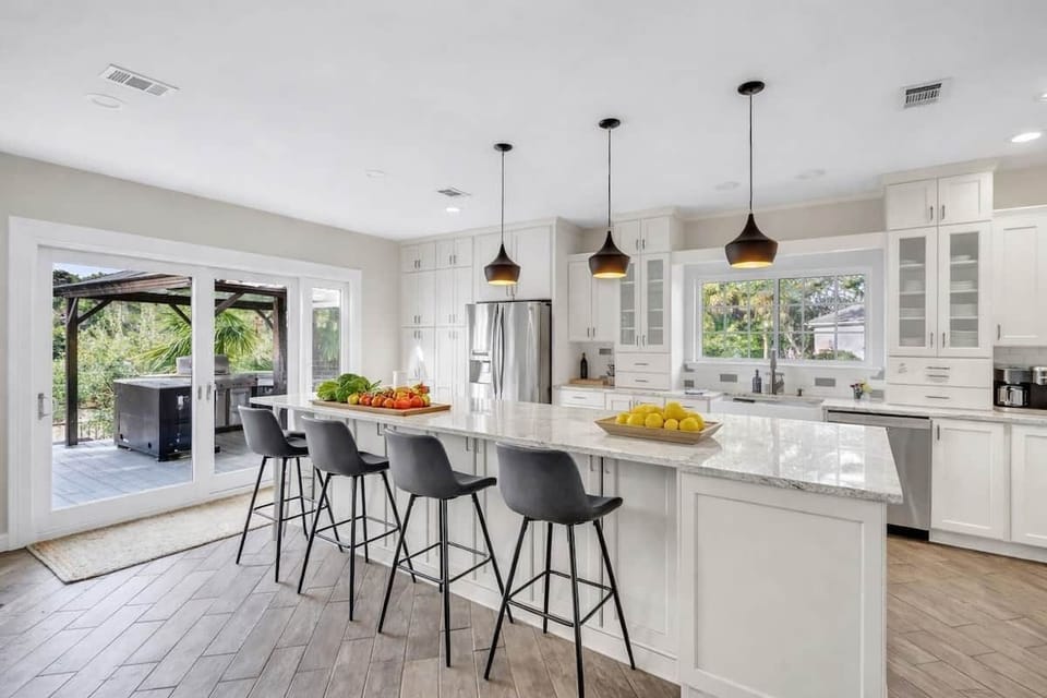 Bright, open plan kitchen with granite counters designed for gathering