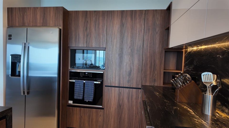 Fully equipped kitchen featuring an oven, microwave, dishwasher, and full-size refrigerator for your convenience.